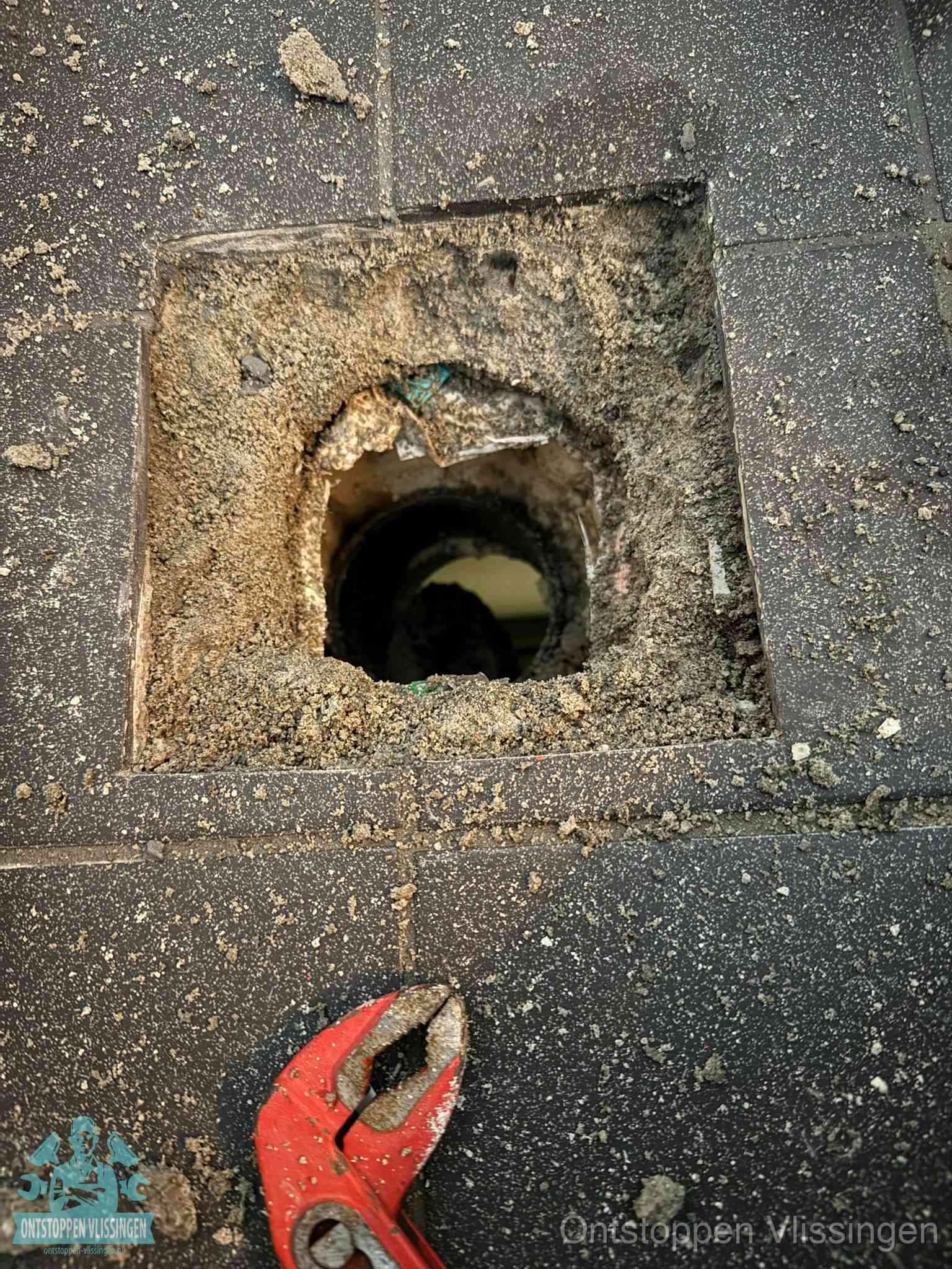 Geopend rioolputje op de erfgrens dat laat zien wie eigenaar is van de riolering in Vlissingen